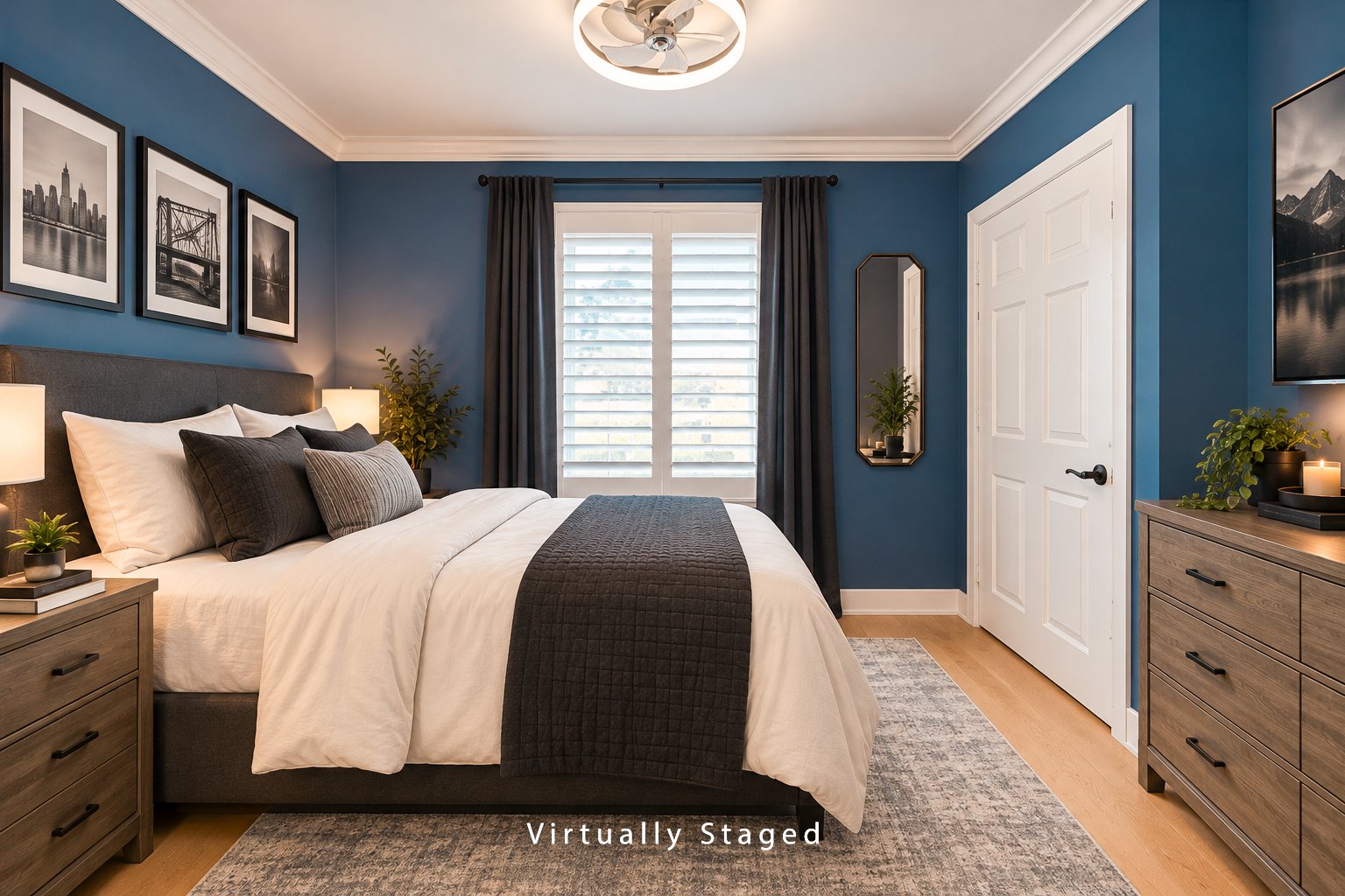 Bedroom with a large bed, blue walls, white shutters, and dark curtains.