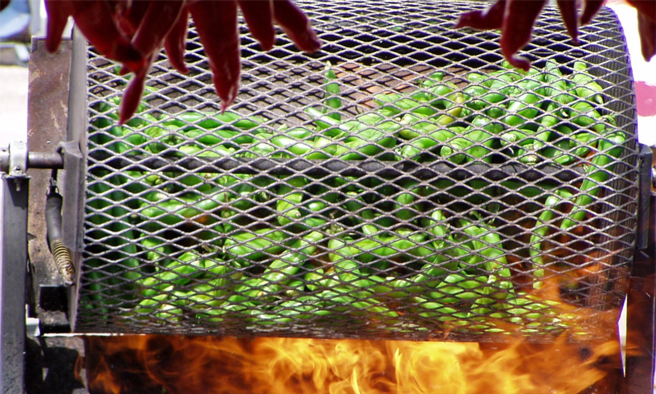 New Mexico green chile tumbling in a traditional fire roaster