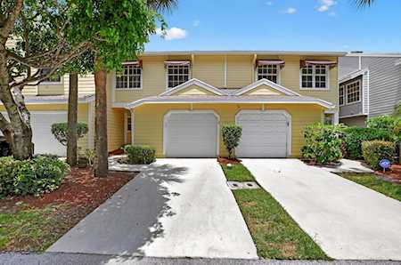 Two-story attached home with twin garage doors, separate driveways, and landscaped front yards.