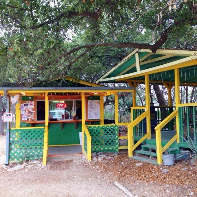 Flores Breakfast and Lunch's colorful outdoor stand beneath mature oak trees.