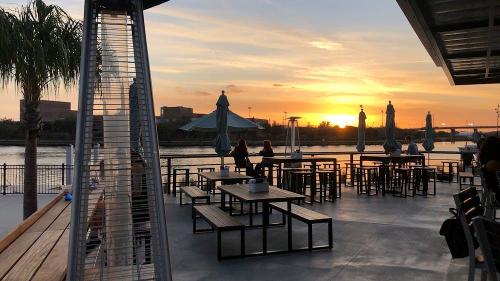 Waterfront restaurant in Tampa Bay during sunset with outdoor dining and scenic views.