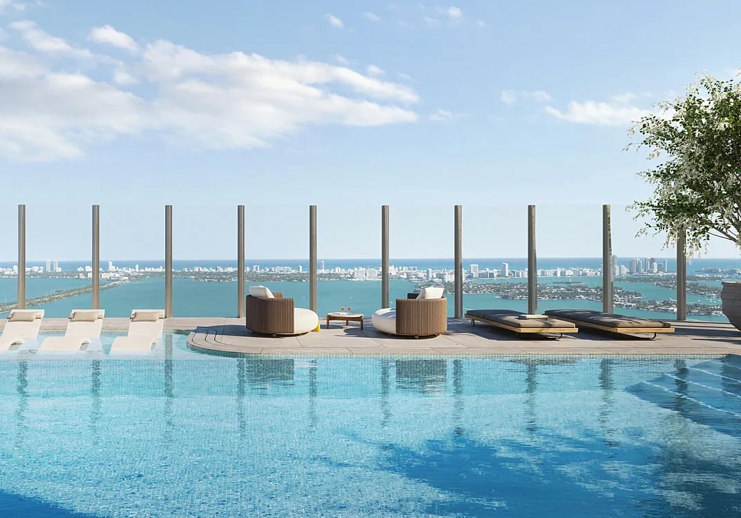 Rooftop pool with a sun deck overlooking waterways and the Miami skyline.