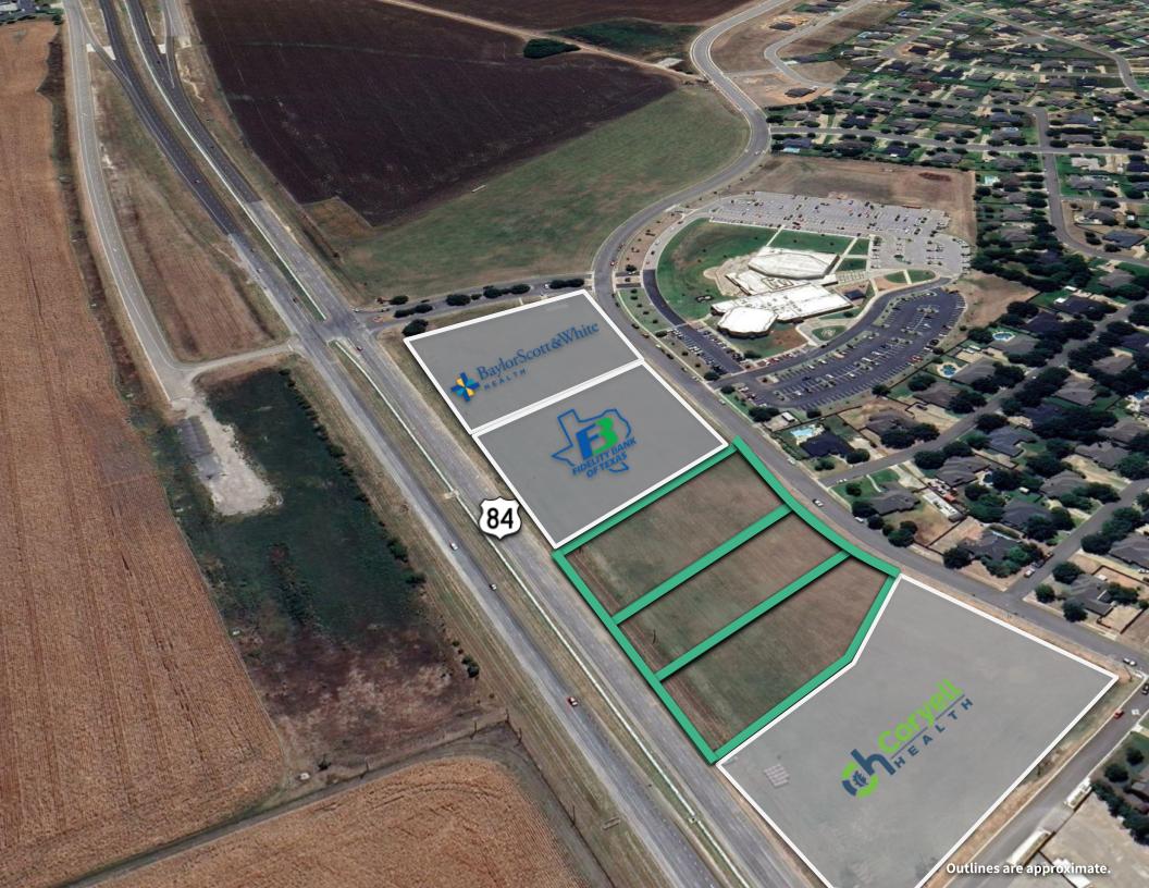 Aerial view of outlined commercial parcels along Highway 84 beside a medical campus.
