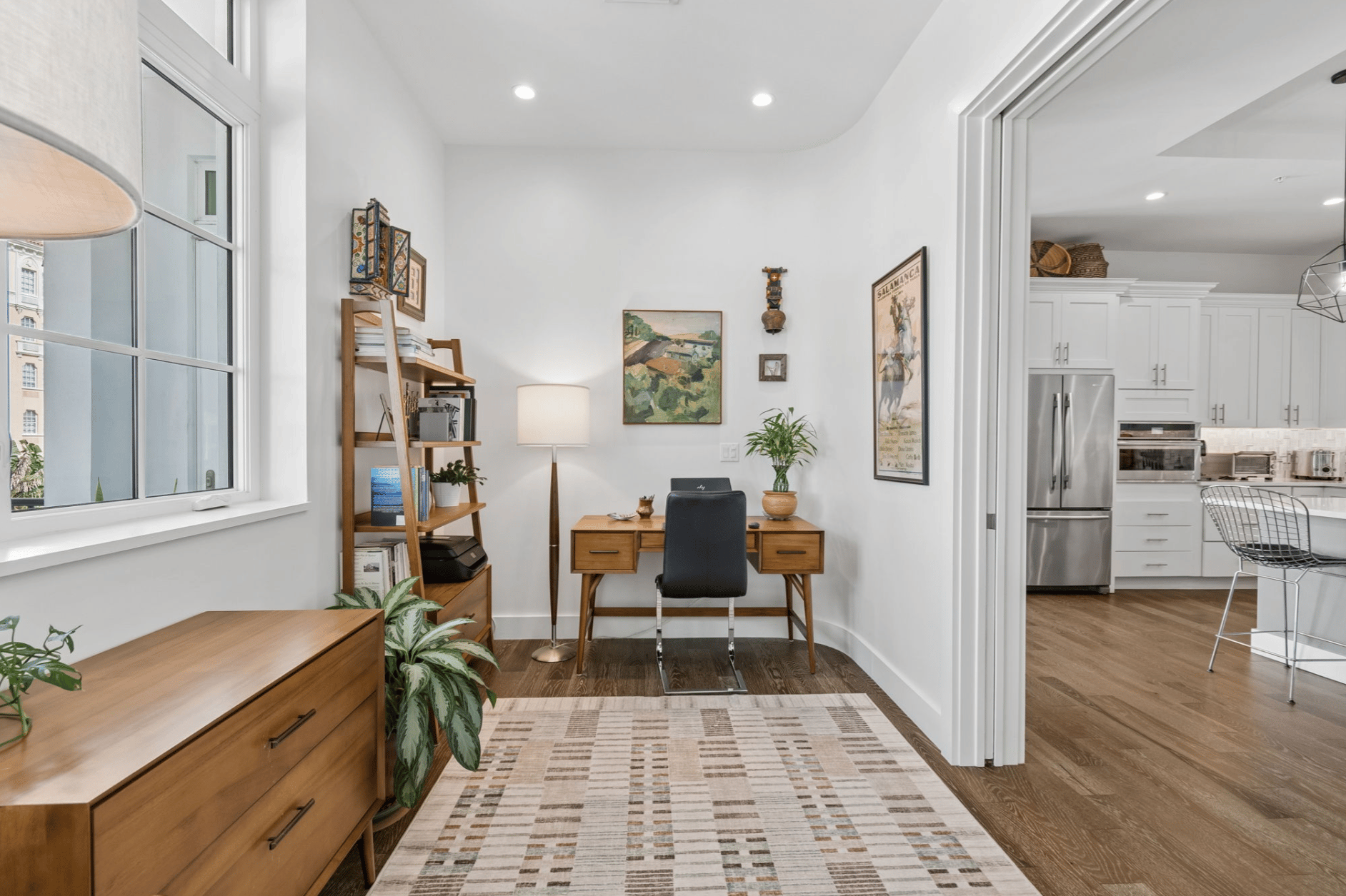 Home office with mid-century desk opening to the kitchen in a Davis Islands condo