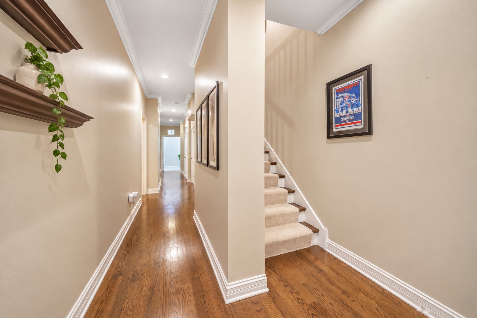 Main-level hallway and private staircase down to the bedroom level in a Chicago duplex down condo