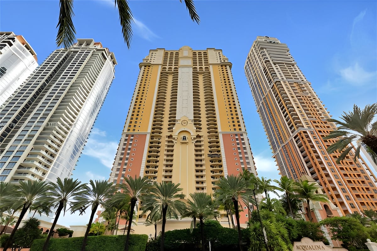Acqualina’s three high-rise towers framed by palm trees.