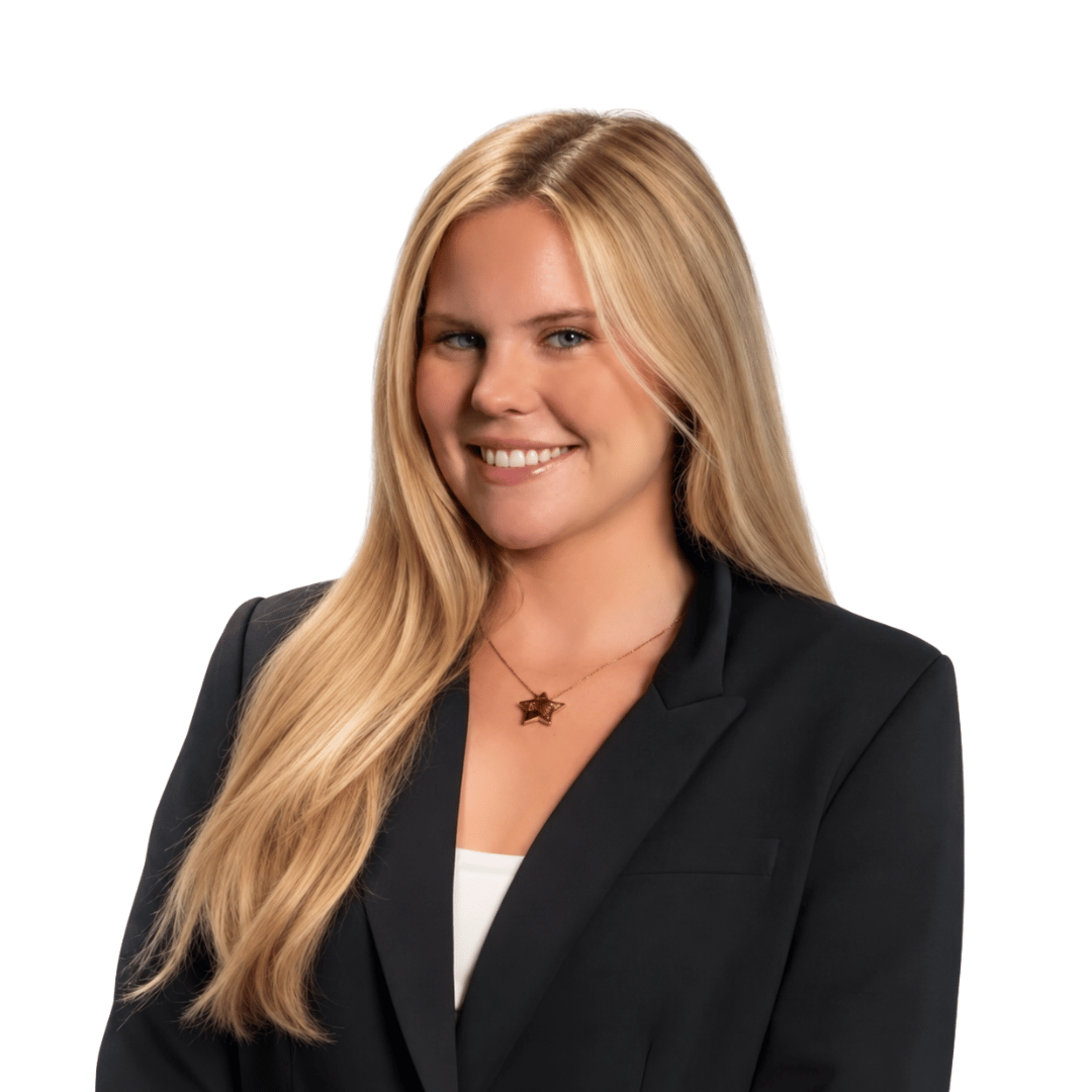 Chelsea Herring smiling in a black blazer and gold star pendant.