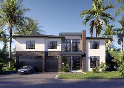 Modern two-story home with dark garage doors, a broad driveway, and palm trees.