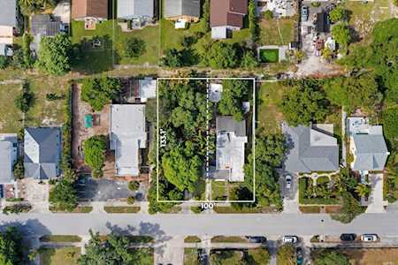 Aerial view of a residential lot outlined among homes, with 100-foot and 150-foot dimensions marked.