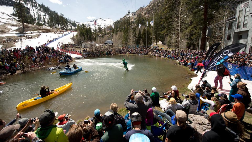 A skier crosses a pond as a crowd watches at a spring event in Squaw Valley.