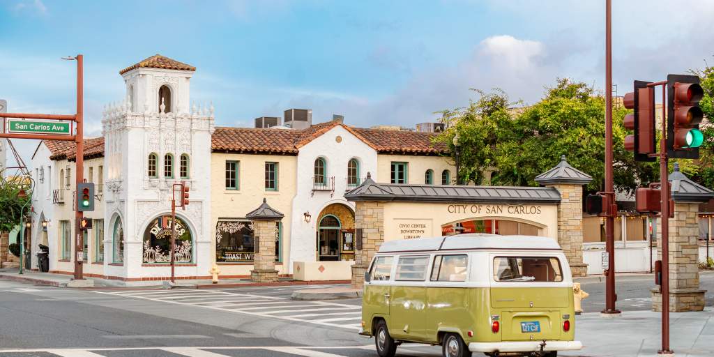 Spanish-style civic center on San Carlos Avenue, with an ornate tower and a vintage green-and-white van.