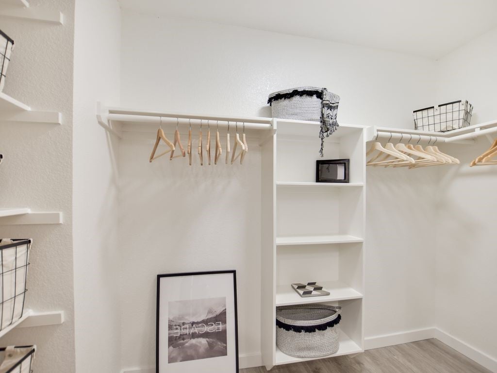 Built-in closet and laundry nook with wood flooring in a Liberty Park condominium in West Lake Hills, Austin.