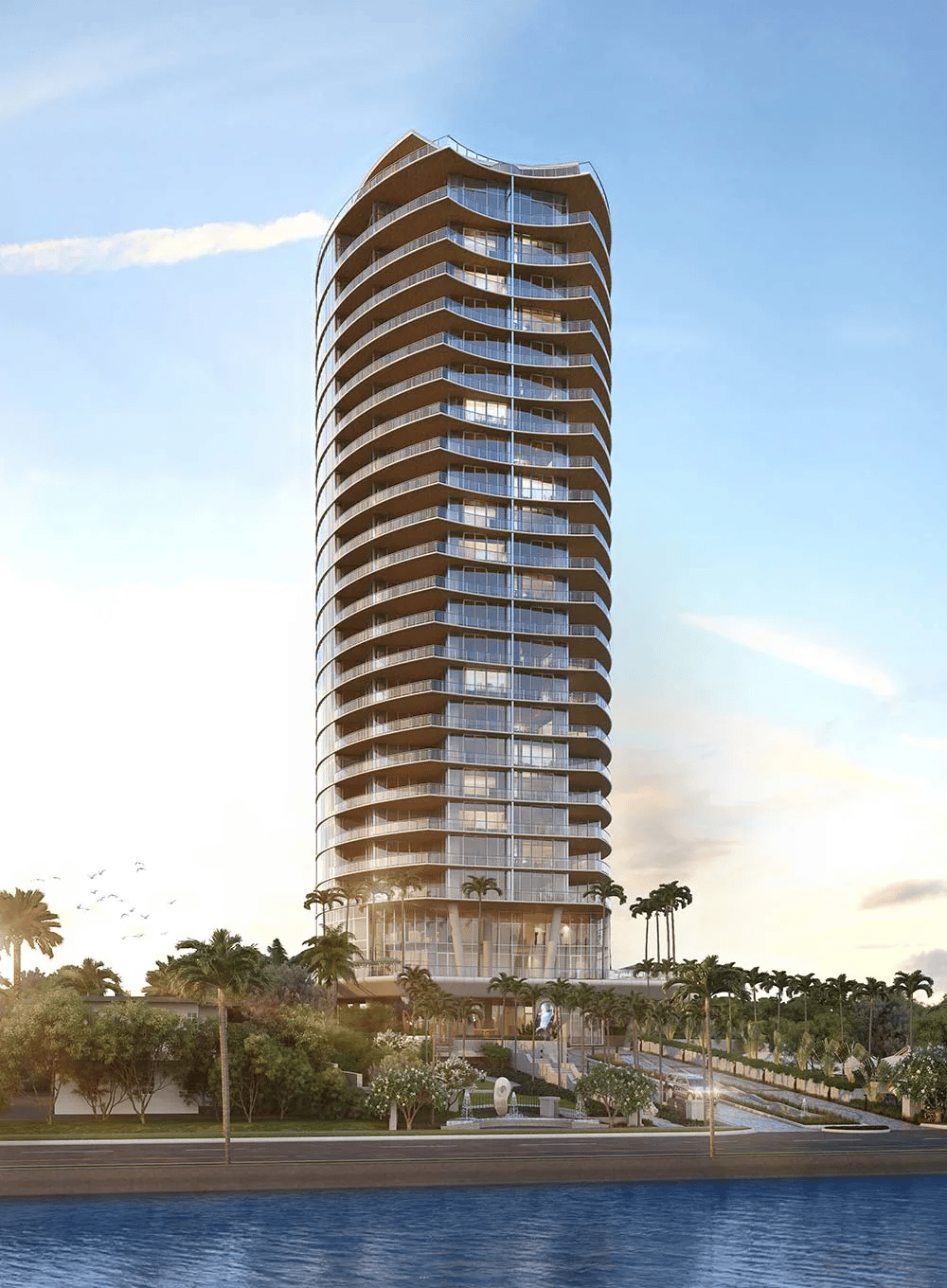 Forté on Flagler tower with curved balconies beside the waterfront at golden hour.
