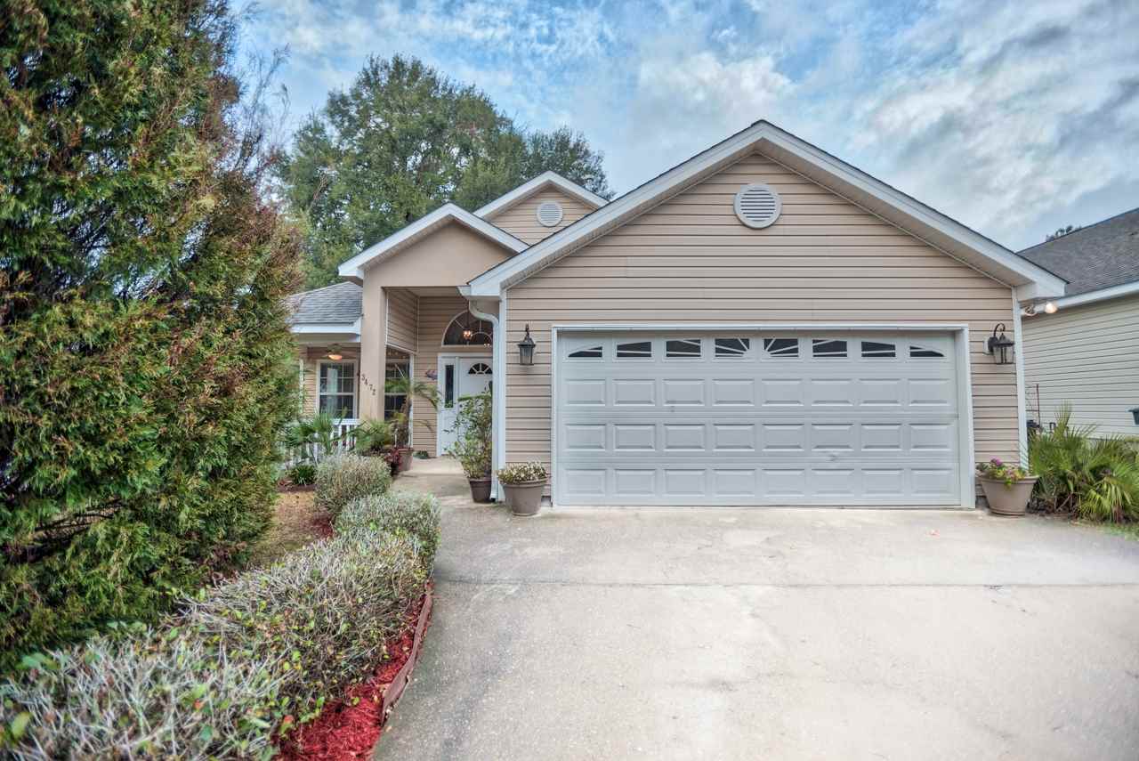 A residential home featuring a garage and a paved driveway, showcasing a welcoming exterior.