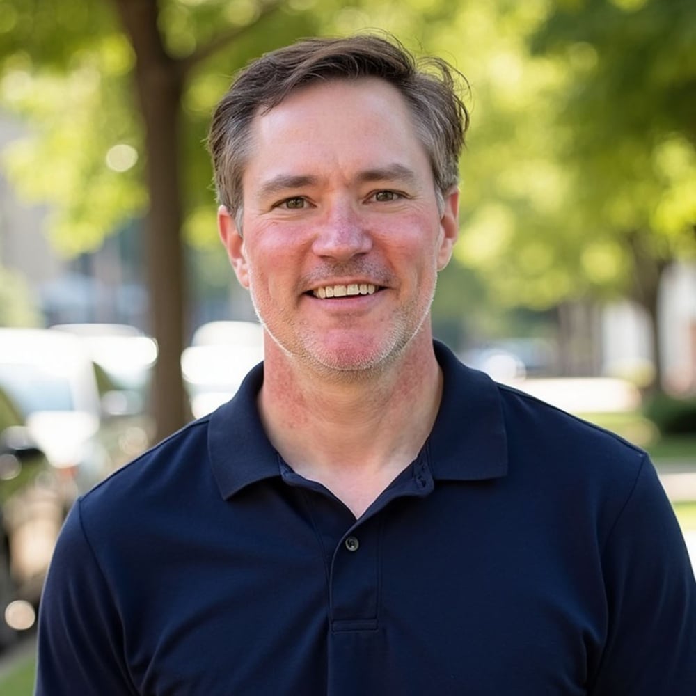 Kevin Gajda smiling in a navy polo outdoors.