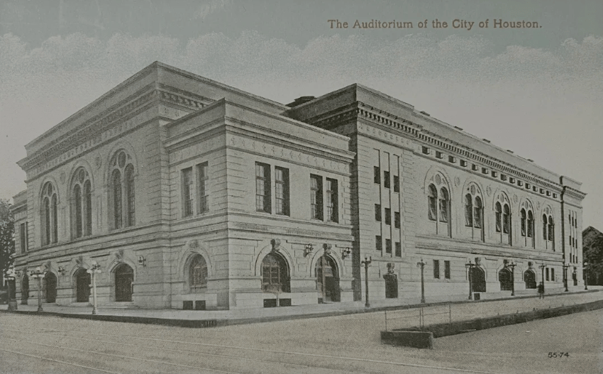 The Auditorium of the City of Houston, a classical-style building with arched windows, photographed from the street.