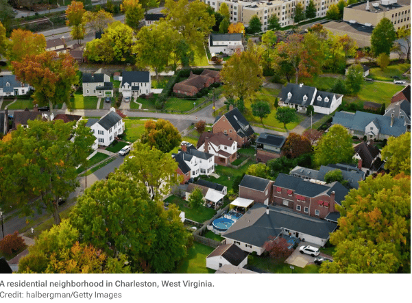 Aerial view of a tree-lined residential neighborhood with detached homes in Charleston, West Virginia.