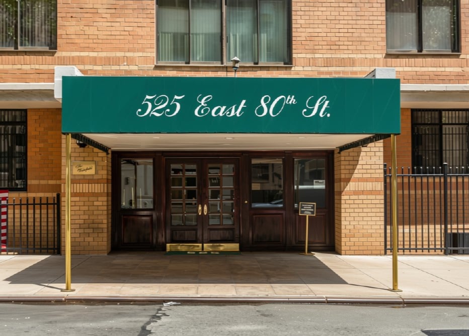 The Wakefield entrance at 525 East 80th Street, with a green awning and dark wooden doors.