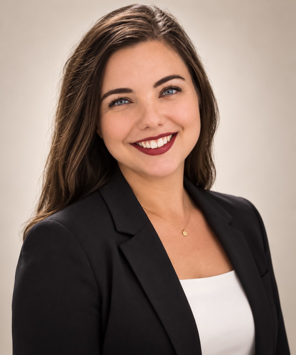 Tara Rasing smiling in a black blazer and white top.