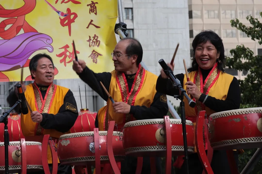 Three traditional drummers play large red drums at the San Francisco Autumn Moon Festival.