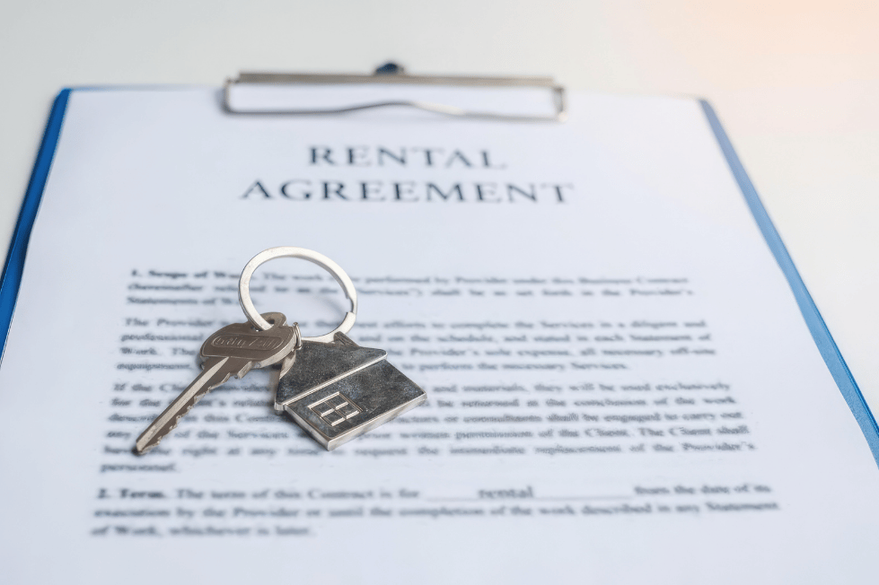 House keys resting on a rental agreement document.