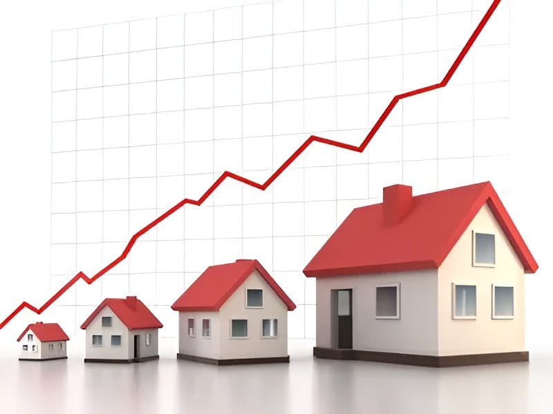 Rising red market graph behind a row of progressively larger houses.