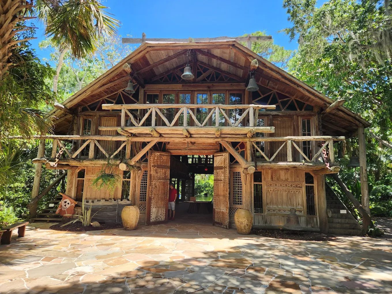 The historic Hall of Giants at McKee Botanical Garden in Vero Beach, a rustic wooden landmark surrounded by tropical foliage