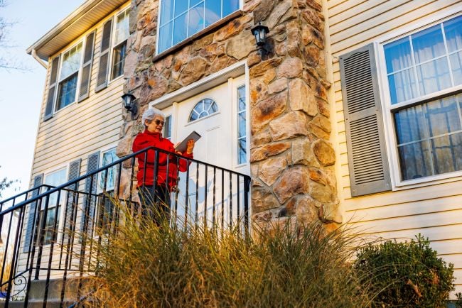 Homeowner reviewing property information outside Monroe County PA residence