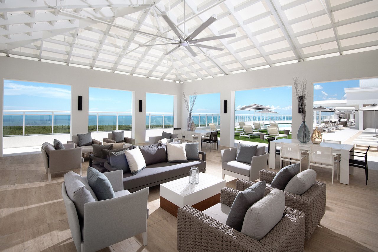 Open-air lounge with ceiling fans and Gulf views at Kalea Bay