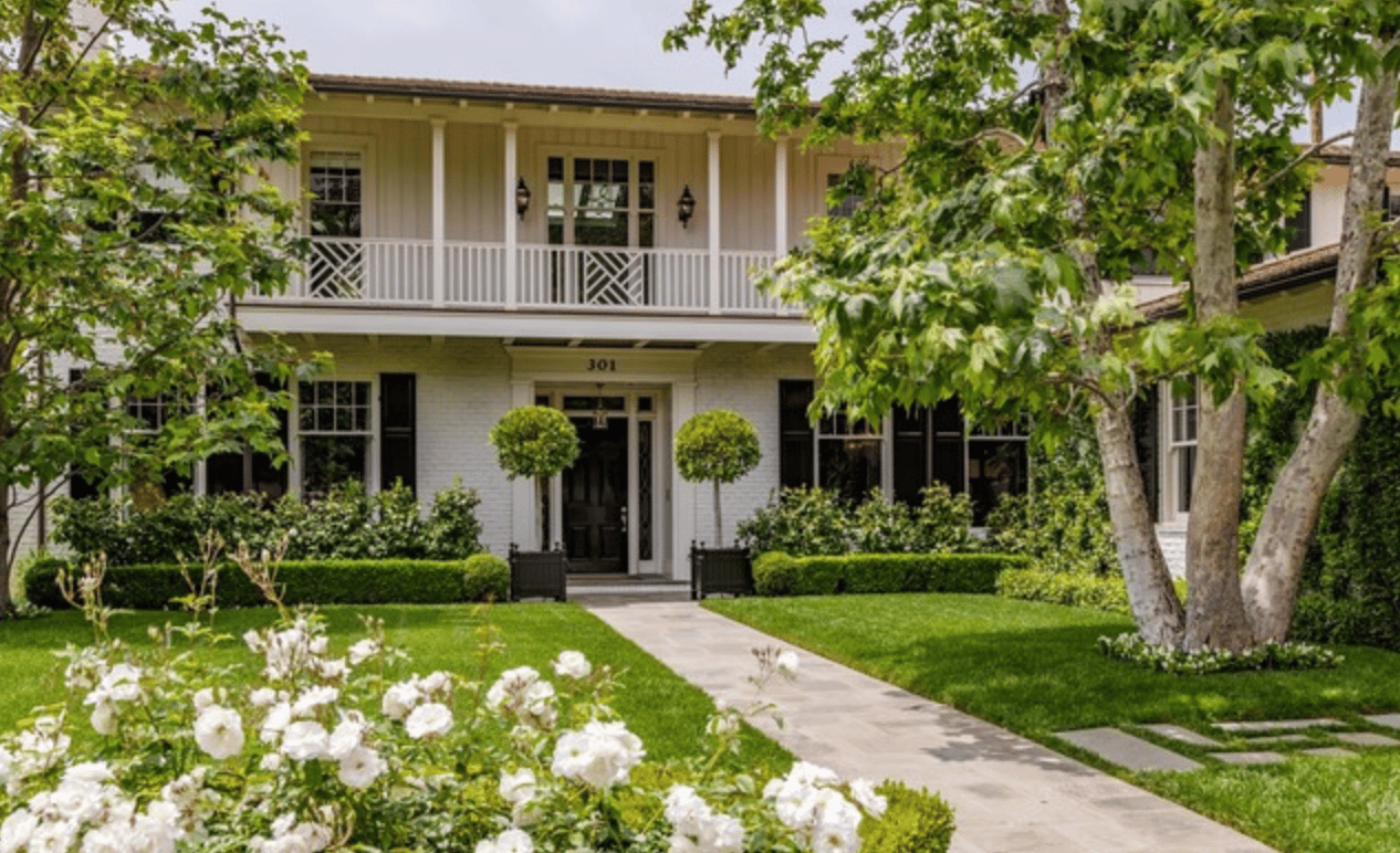 Behind gates covered in white roses