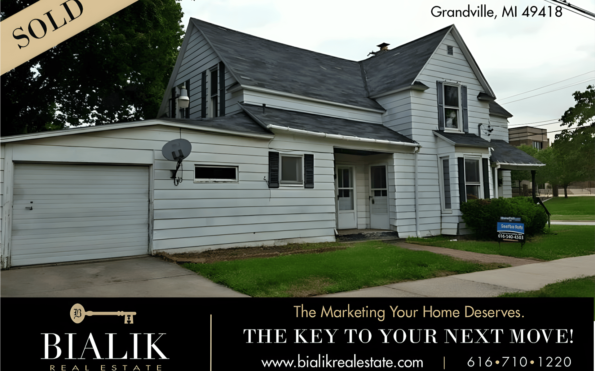 White two-story Grandville home with attached garage, marked sold.