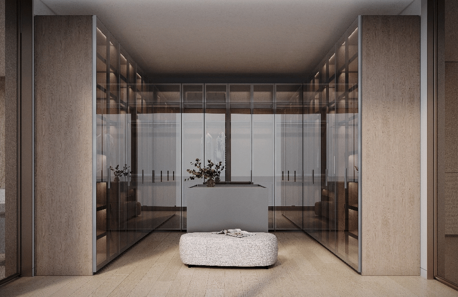 Walk-in closet with glass-fronted wardrobes, a central island, and an upholstered ottoman.