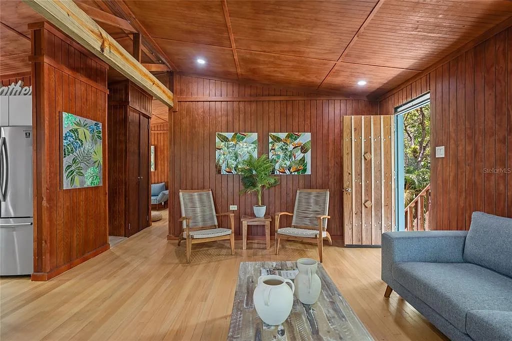 Cozy tropical living room with wood paneling