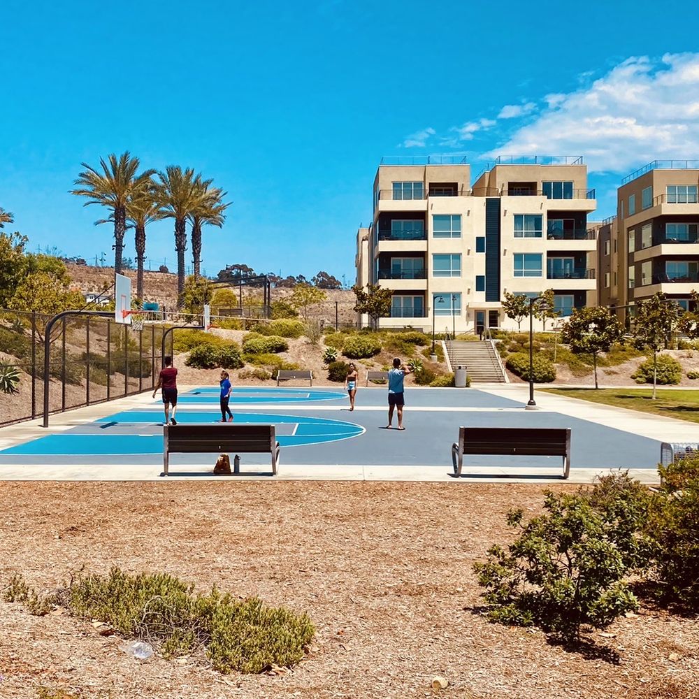 Modern condos and a community basketball court in Kearny Mesa, San Diego, showcasing the neighborhood’s walkable urban lifestyle and residential growth.