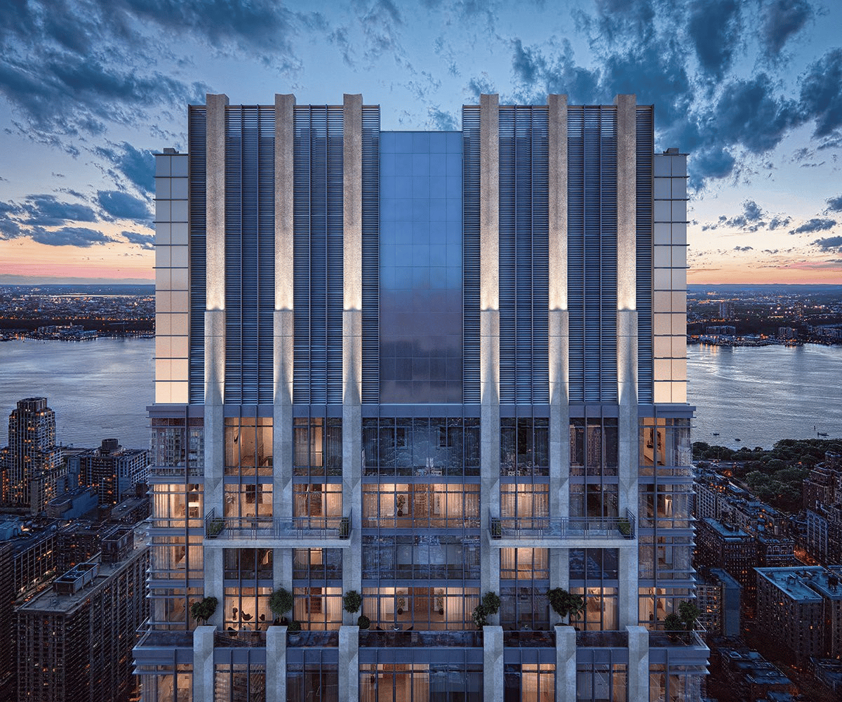 200 Amsterdam Avenue tower at dusk, with a glass-and-stone facade overlooking the Hudson River.