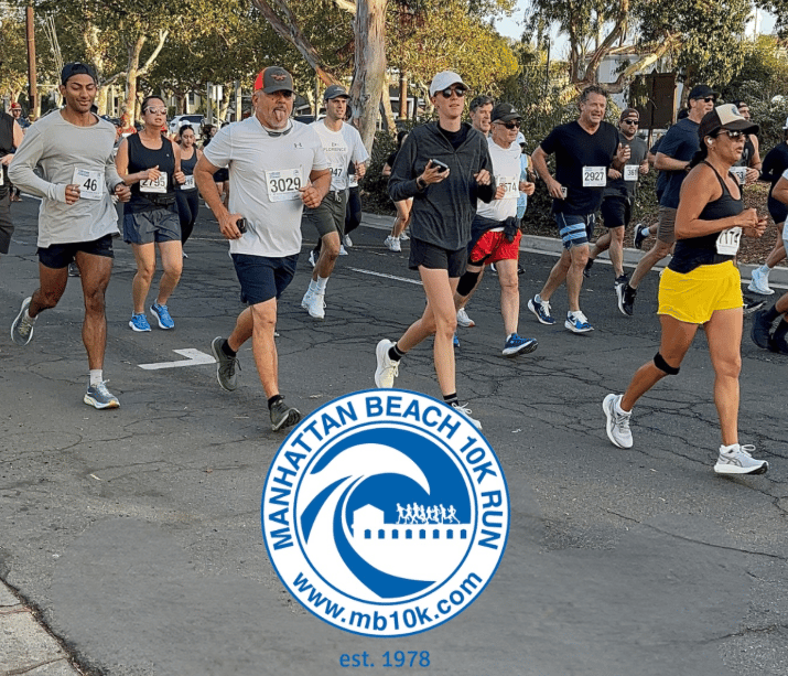 Runners race along a tree-lined street at the Manhattan Beach 10K.
