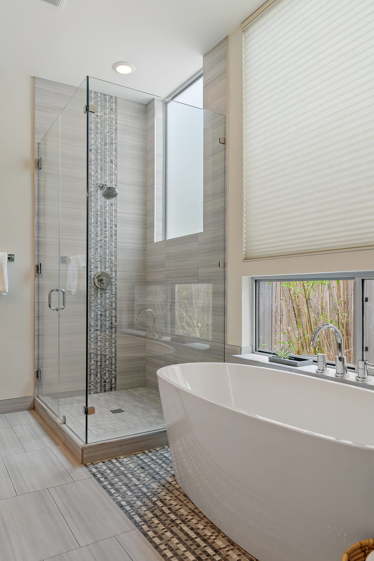 Primary bathroom glass shower with a window for natural light at 34 Margranita Crescent, Tarrytown, Austin, TX.