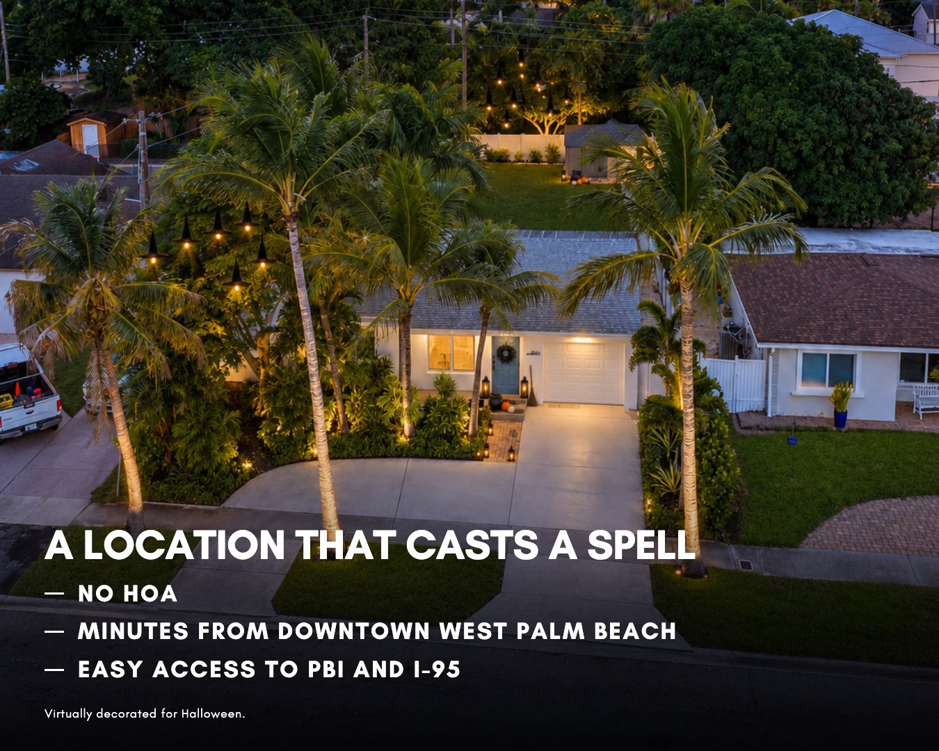 Aerial view of a renovated single-family home on a palm-lined street near downtown West Palm Beach, Florida, at dusk