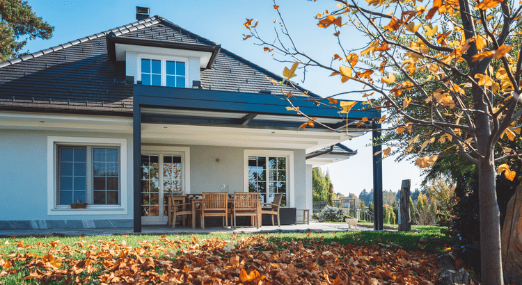 A charming house featuring a covered porch and a spacious covered patio, perfect for outdoor relaxation and gatherings.