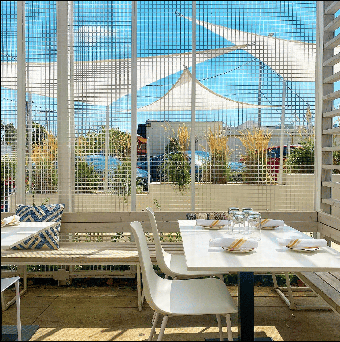 Colorful outdoor dining patio at OSO Paseo in the Paseo Arts District Oklahoma City during fall evening.