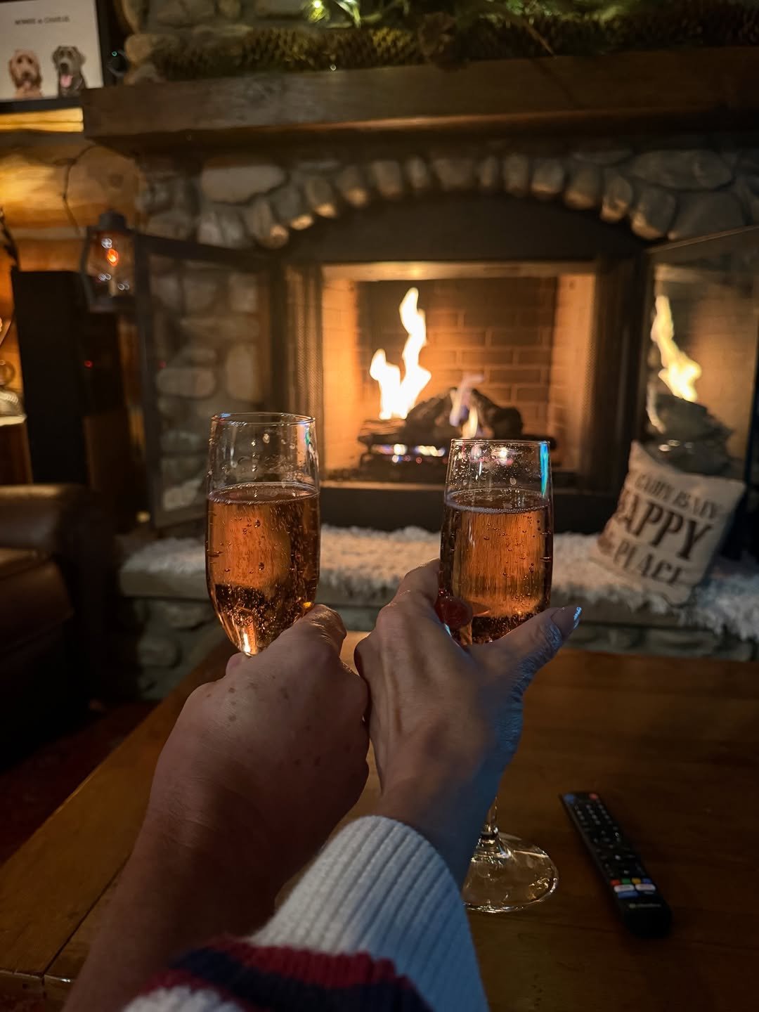 Mountain New Year's Eve celebration with fireworks exploding over snow-capped peaks, people cheering with champagne glasses, capturing joyful Colorado vibes and community spirit.