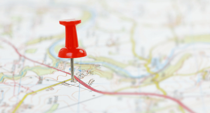 Red pushpin marking a location on a street map.