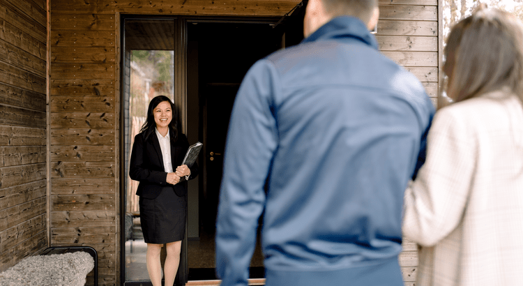 A woman in a business suit stands confidently in front of a closed door, exuding professionalism and determination.