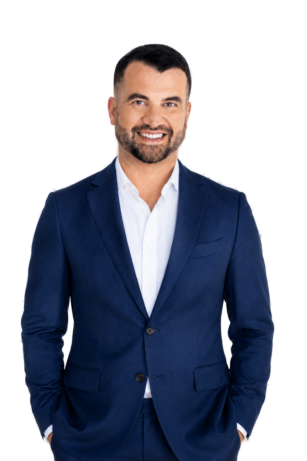 Eric Gage smiling in a navy suit and white shirt