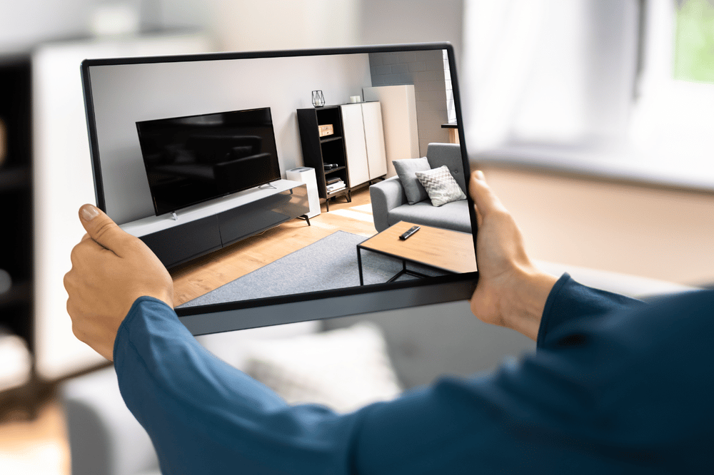 Person explores a modern living room virtually on a tablet.