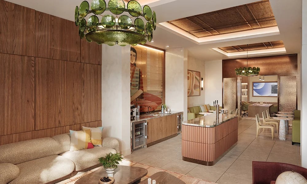 Residential lounge with a cream sofa, wood-paneled walls, and green glass pendant lights.