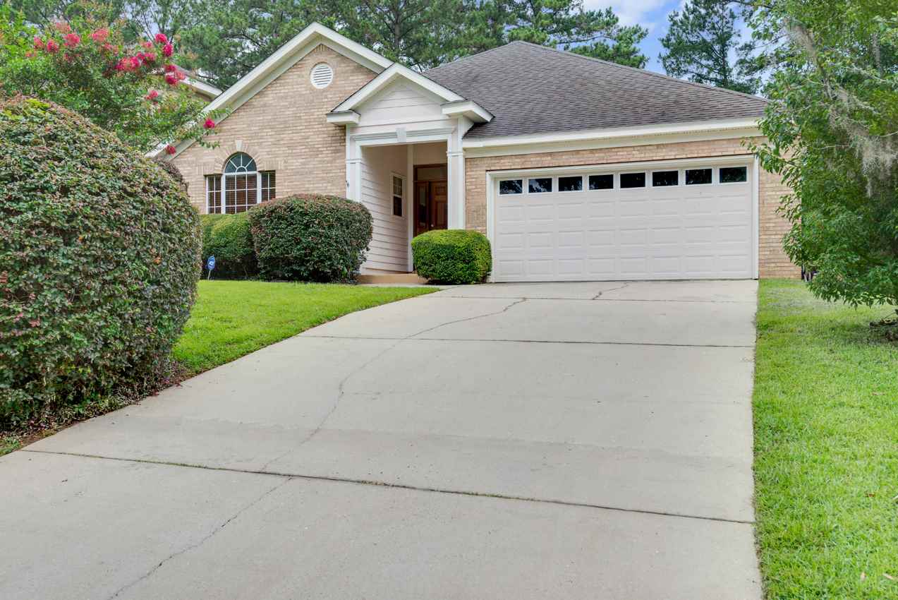 A residential home featuring a driveway leading to an attached garage.