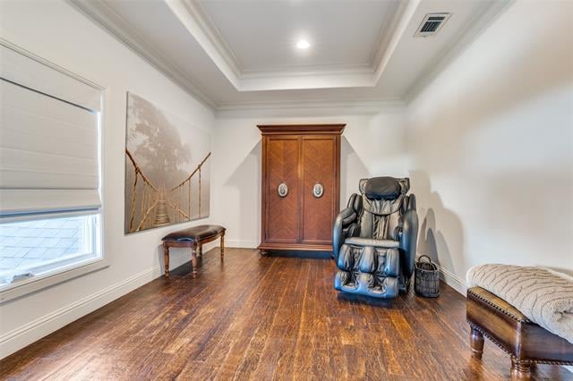 Room with a massage chair, wooden cabinet, polished wood floors, and a cushioned bench.