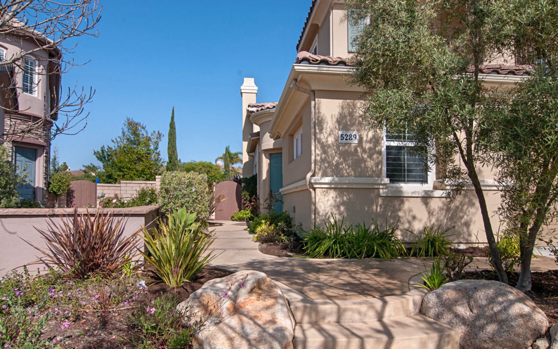 Two-story home with a landscaped walkway and address number 5289.