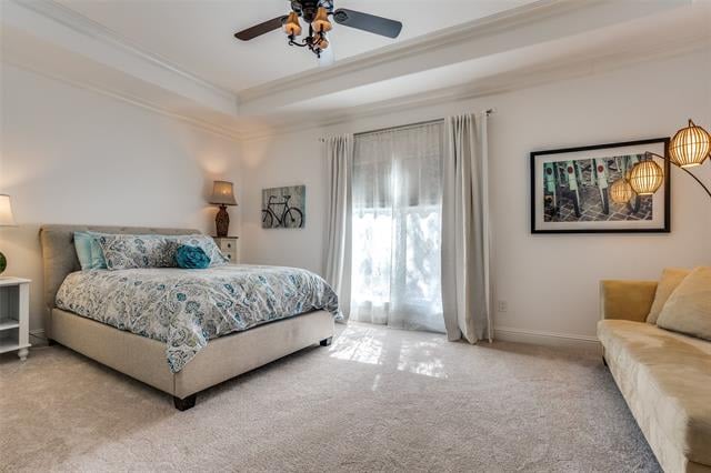 Bedroom with a patterned upholstered bed, sheer-curtained window, and cream sofa.